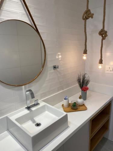 a bathroom with a white sink and a mirror at Eco resort Praia dos Carneiros in Praia dos Carneiros