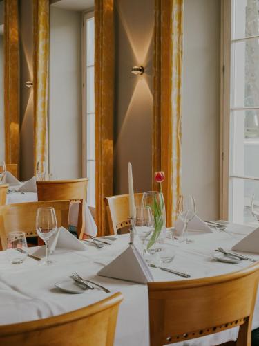a table with white table cloth and wine glasses at Bad Hotel Überlingen in Überlingen