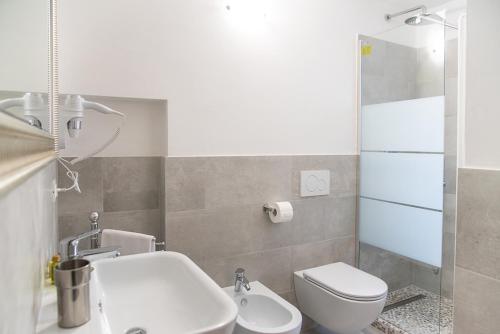 a bathroom with a white toilet and a sink at Coco Places Rooms Santa Maria Novella, Centro Storico in Florence