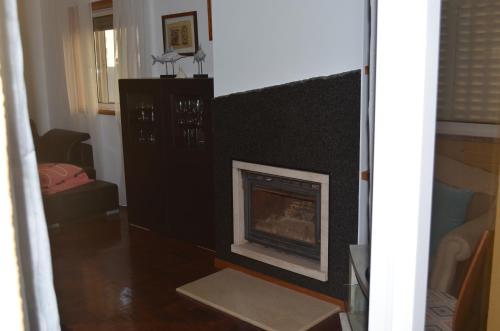 a living room with a fireplace in a room at ESPAÇO ALVIM in Esmoriz