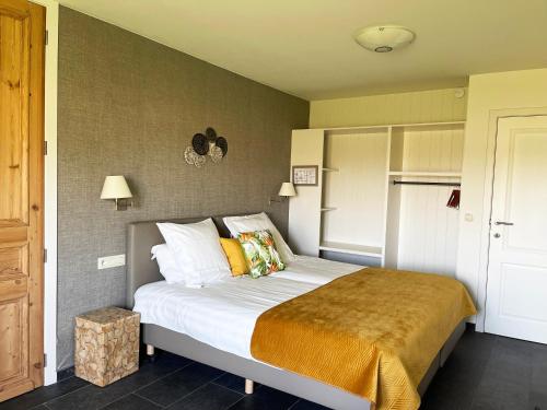 a bedroom with a large bed in a room at Hotel het Elsland in Wervik