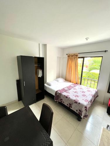 a bedroom with a bed and a window at Casa Santiago Mayor in Cali