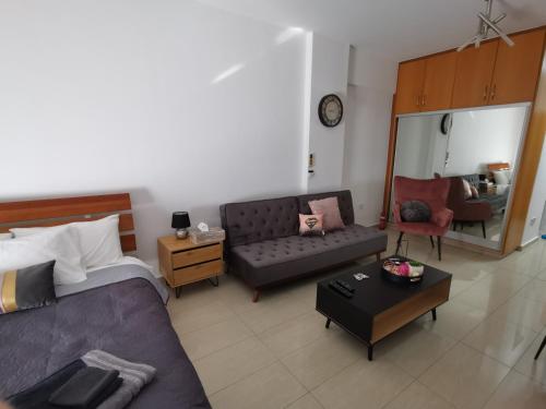 una sala de estar con una cama y un sofá en Flat111-Adults only, en Limassol