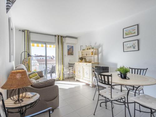 a living room with a couch and a table and chairs at Apartment Pattaya-8 by Interhome in Empuriabrava