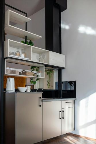 a kitchen with white and silver cabinets in a room at MariaApartments in Bitola