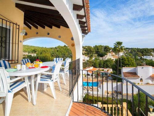 a balcony with a table and chairs and a view at Holiday Home La Repere by Interhome in Benissa