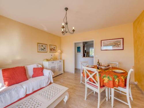 a living room with a couch and a table at Apartment Les Pins Dorés-2 by Interhome in Sainte-Maxime