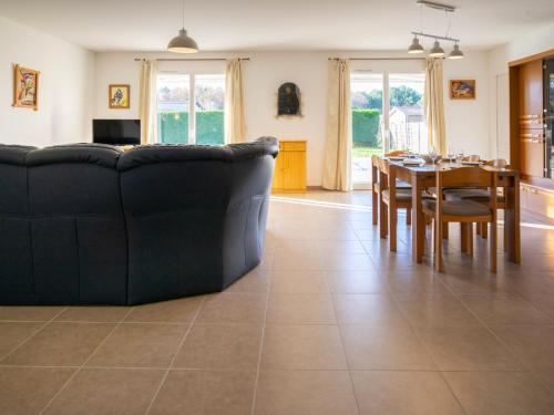a living room with a couch and a table at Holiday Home Philibert by Interhome in Carcans