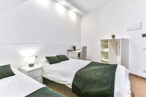 Vuode tai vuoteita majoituspaikassa Laramond Barcelona Rooms