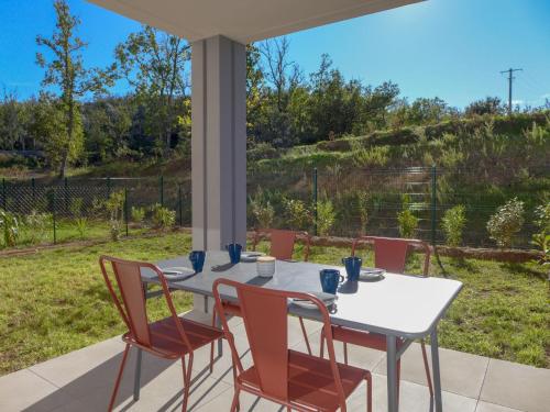 a white table and chairs on a patio at Apartment Royal Green by Interhome in Roquebrune-sur-Argens