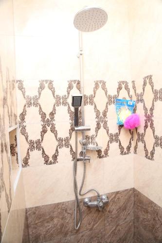 a shower with a shower head in a bathroom at Ashtarak-1 Modern Apartment in Ashtarak