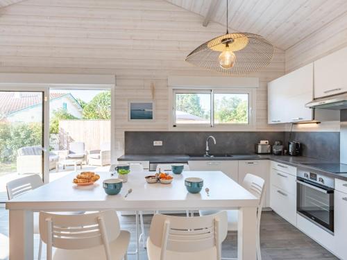 a kitchen with a white table and chairs at Holiday Home Villa Horizon by Interhome in Lacanau-Océan