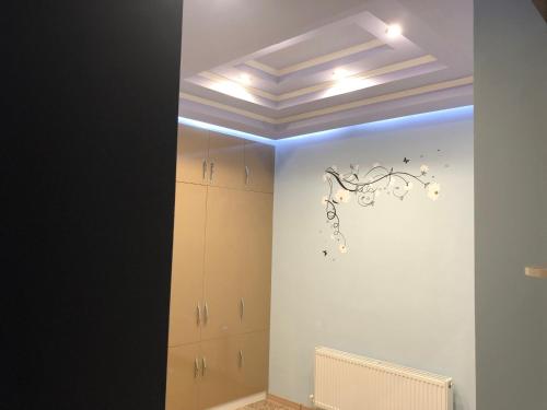 a room with a wall with a chandelier on it at Ashtarak-1 Modern Apartment in Ashtarak