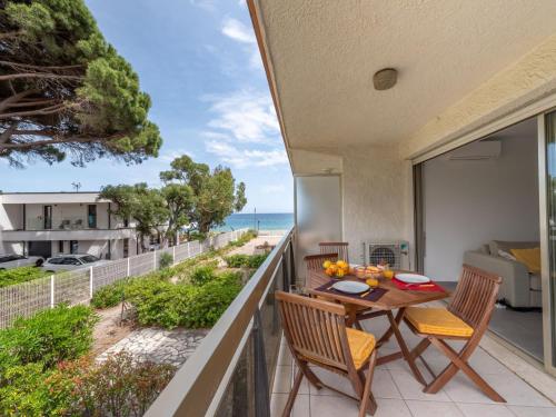 a balcony with a table and chairs and the ocean at Studio De la Plage-3 by Interhome in Cavalaire-sur-Mer