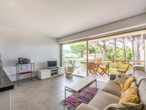 a living room with a couch and a tv at Studio De la Plage-3 by Interhome in Cavalaire-sur-Mer