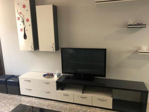 a living room with a flat screen tv on a entertainment center at Ashtarak-1 Modern Apartment in Ashtarak