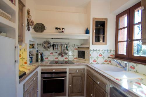 a kitchen with a sink and a stove top oven at Villa Golf Azur in Saint-Raphaël