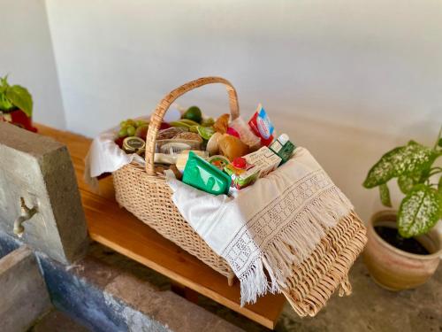 a basket of fruits and vegetables on a table at Casa do Avô José Alves in Praia da Vitória