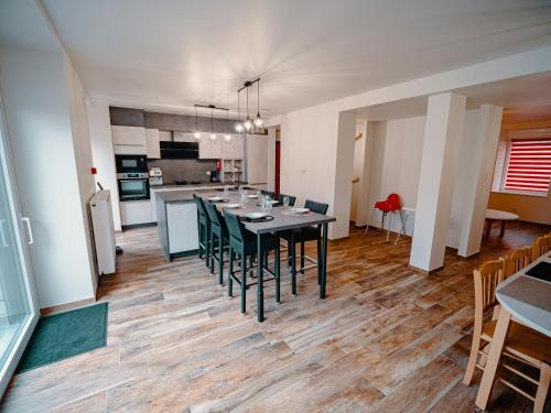 a dining room and kitchen with a table and chairs at La porte du paradis in La Roche Madoux