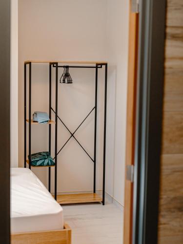 a bedroom with a mirror next to a bed at La porte du paradis in La Roche Madoux