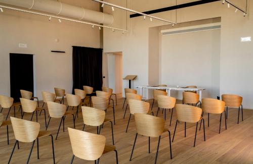a room with rows of chairs in a room at Casa di Langa in Cerretto Langhe