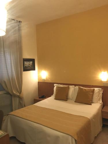a bedroom with a large bed with two pillows at Hotel Villa Fernanda in Massa Lubrense
