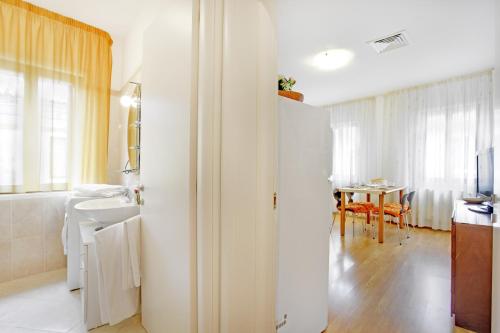 a bathroom with a sink and a table at Bricola Biennale Apartments in Venice