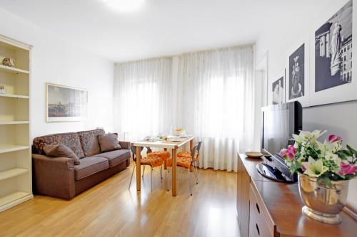 a living room with a couch and a table at Bricola Biennale Apartments in Venice