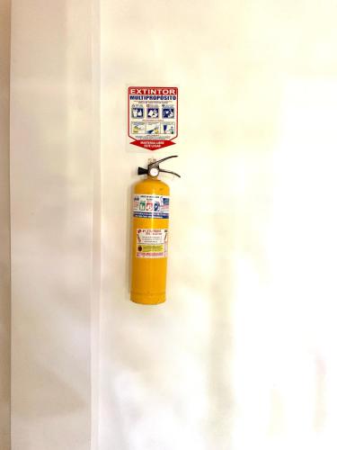 a fire extinguisher hanging on a wall at Casa Santiago Mayor in Cali