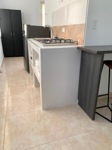 a kitchen with a sink and a stove at Casa Santiago Mayor in Cali