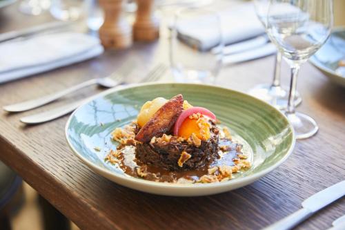 a plate of food on a wooden table at Maison du Val - Les Maisons de Campagne in Saint-Germain-en-Laye