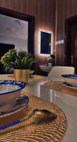 a table with plates and bowls on top of it at هتان السودة Hattan Al Soudah in Suda