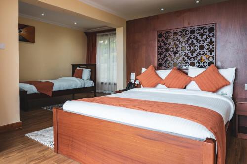 A bed or beds in a room at Lake Elementaita Mountain Lodge
