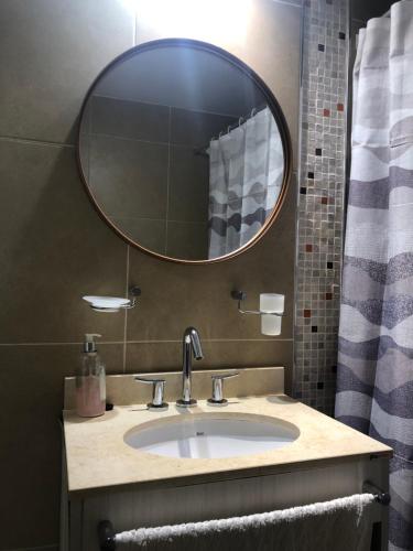 a bathroom with a sink and a mirror at Departamento en Santa Fe, Capital. Con cochera y pileta in Santa Fe