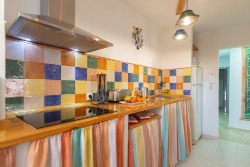 una cocina con azulejos coloridos en la pared en Luminoso apartamento de dos habitaciones con terraza y parking en el centro, en Málaga