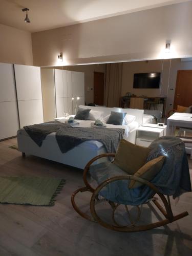 a bedroom with a bed and a chair in it at Room and Apartments Antea in Rovinj