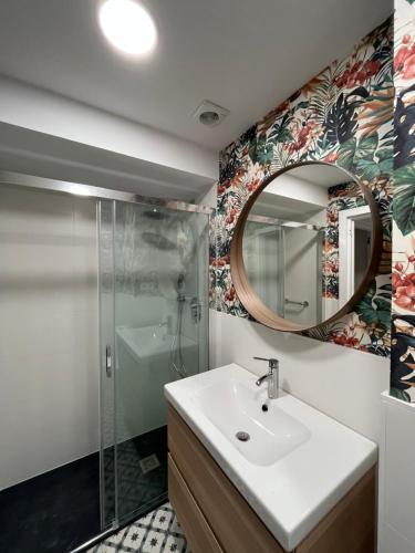 a bathroom with a sink and a mirror at Apartment for 4 in Lejona Casa Natalia NO ELEVATOR in Leioa