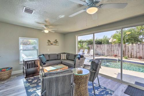 a living room with a couch and a table at Pet-Friendly Merritt Island Home with Heated Pool in Merritt Island