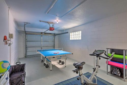 a gym with a ping pong table in a room at Pet-Friendly Merritt Island Home with Heated Pool in Merritt Island