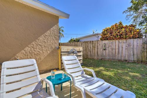 two white chairs and a table in a yard at Pet-Friendly Merritt Island Home with Heated Pool in Merritt Island