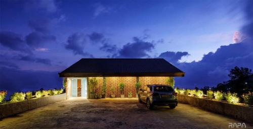 a car parked in front of a building at night at Vantage hills Haputale in Haputale