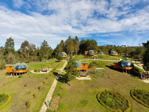 an aerial view of a group of tents in a field at Glamping y Chalet Aventura Park Villa De Leyva La Periquera in Villa de Leyva