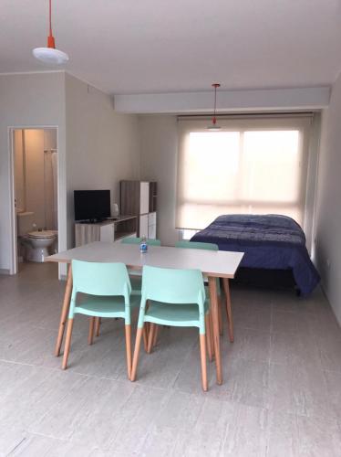a room with a table and two chairs and a bed at Sol de Octubre 3 Hipólito Vieytes Norte y Talcahuano in San Juan