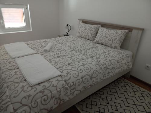 a bedroom with a bed with a laptop on it at Apartman Tanja in Divčibare