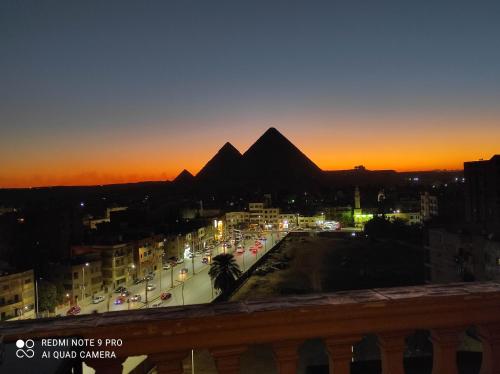 a view of the pyramids of giza at sunset at pyramids view suite/vista piramidi in Cairo