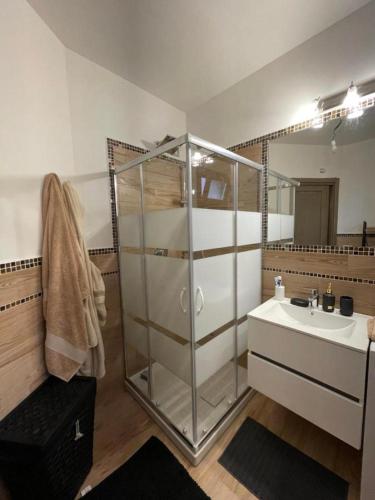 a bathroom with a glass shower and a sink at Casa Manzoni in La Maddalena