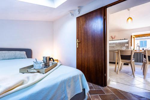 a bedroom with a bed with a wooden door at CASA ANNA in Laiatico