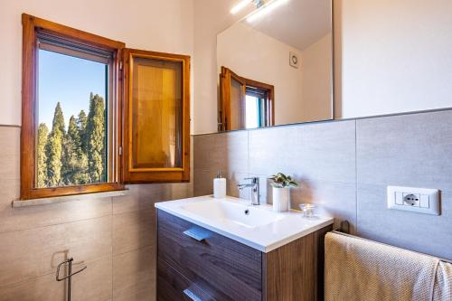 a bathroom with a sink and a window at CASA ANNA in Laiatico