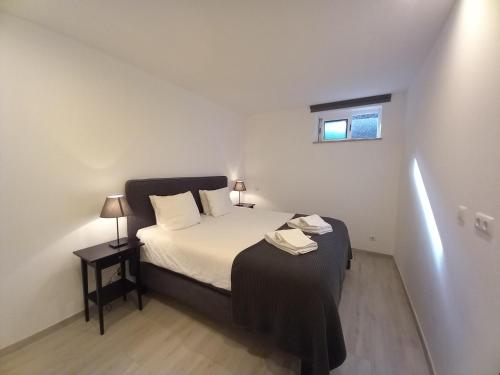 a small bedroom with a bed and a window at Lopes Apartment - Belch1952 in Lagos