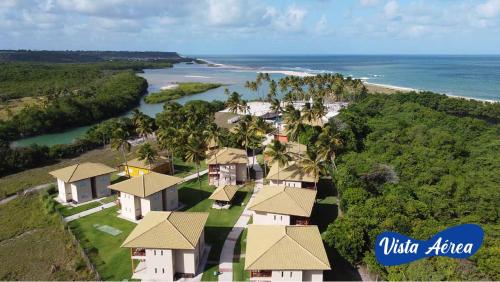 an aerial view of a resort near the ocean at Asenza Beach Resort All Inclusive in Pitimbu